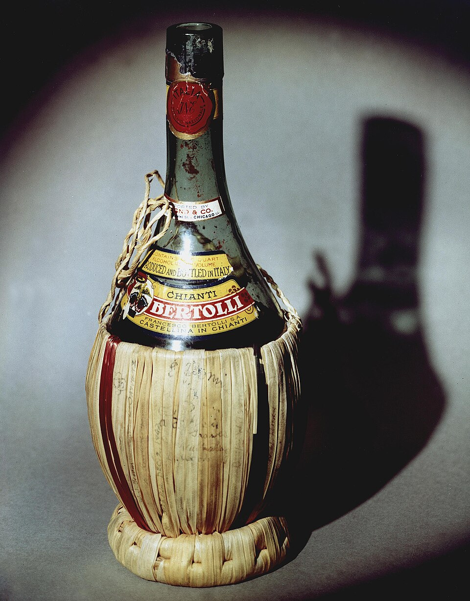 A vintage Chianti bottle in its traditional straw basket